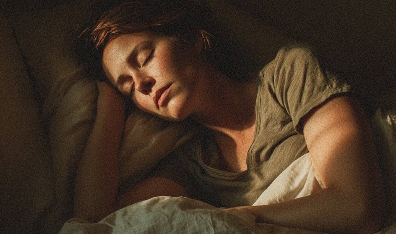A woman sleeping with low light across her face