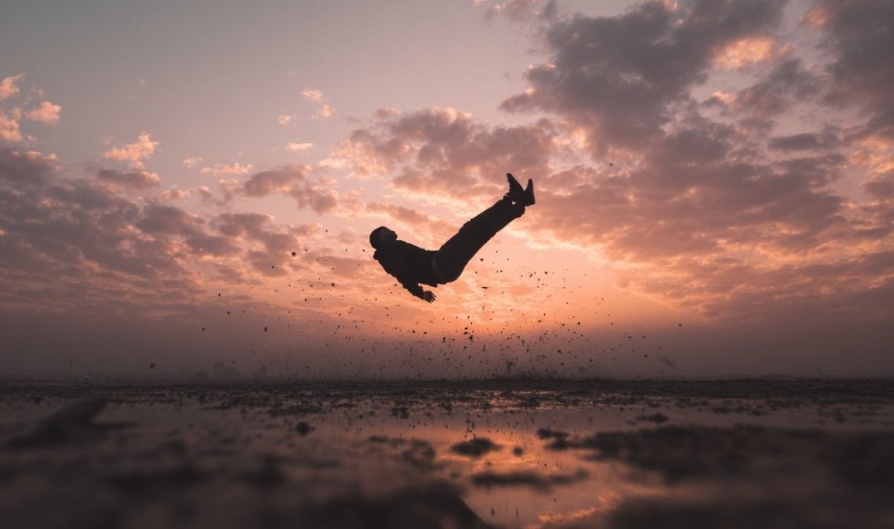 Surreal scene of people and objects falling through the sky